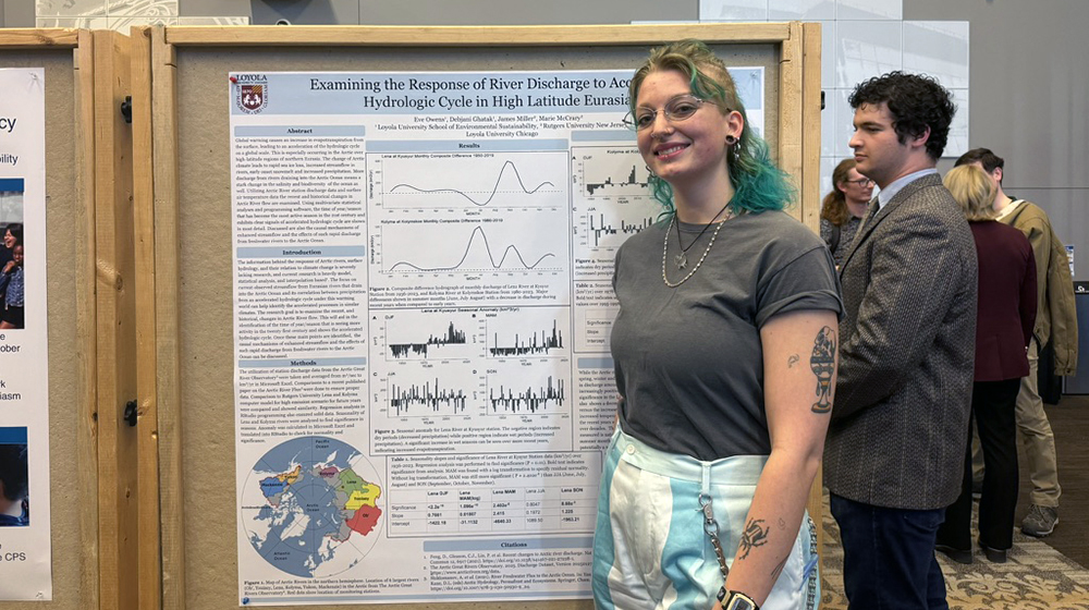 student Eve Owens with her research poster